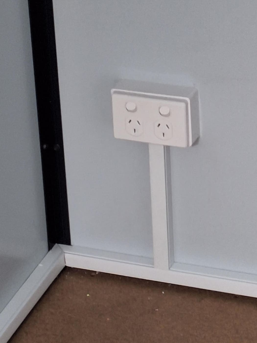 New double power point installed on a wall beside a doorway