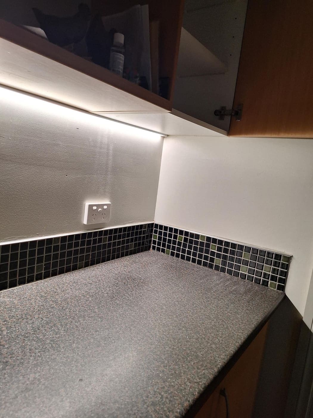 Power point installed beside a glass mosaic feature-tile border