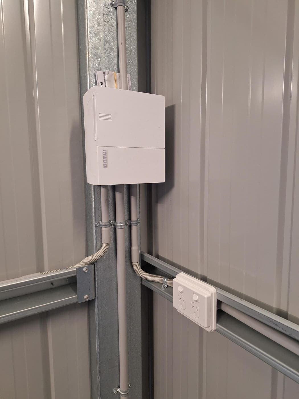 Surface conduit wiring and a double power point installed in a steel shed