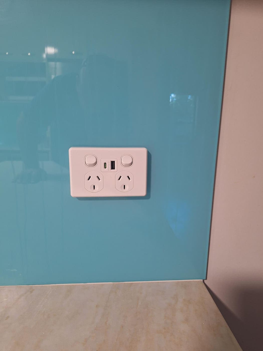 Power point with USB and USB-C charging on a teal glass splashback