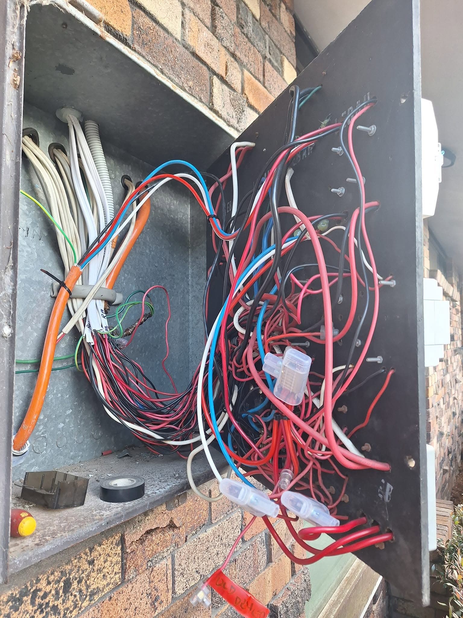 Coloured wiring inside an electrical junction box being repaired