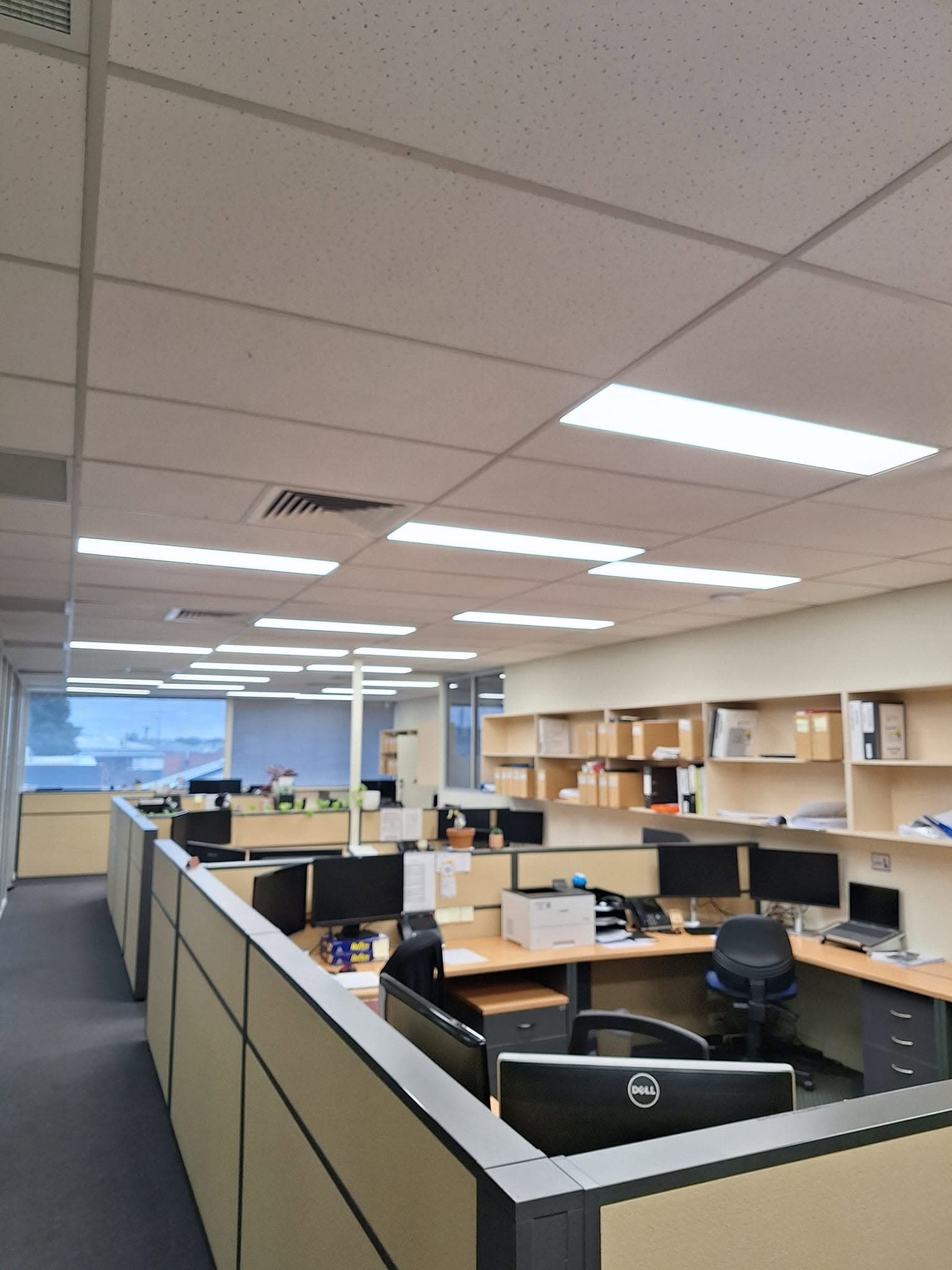 Recessed panel lighting across a commercial office ceiling